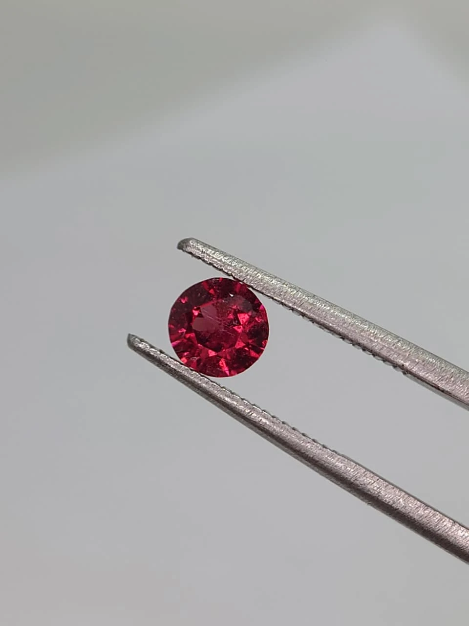 0.6ct Natural Round Faceted Malaya Garnet from Tanzania — view 4